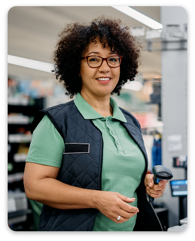 Happy woman working as cashier at supermarket checkout and looking at camera.