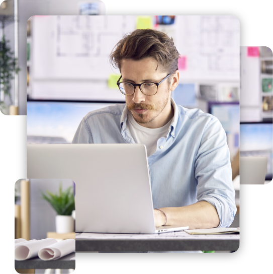 Male And Female Architects In Office Working At Desk On Laptop And Desktop Computers