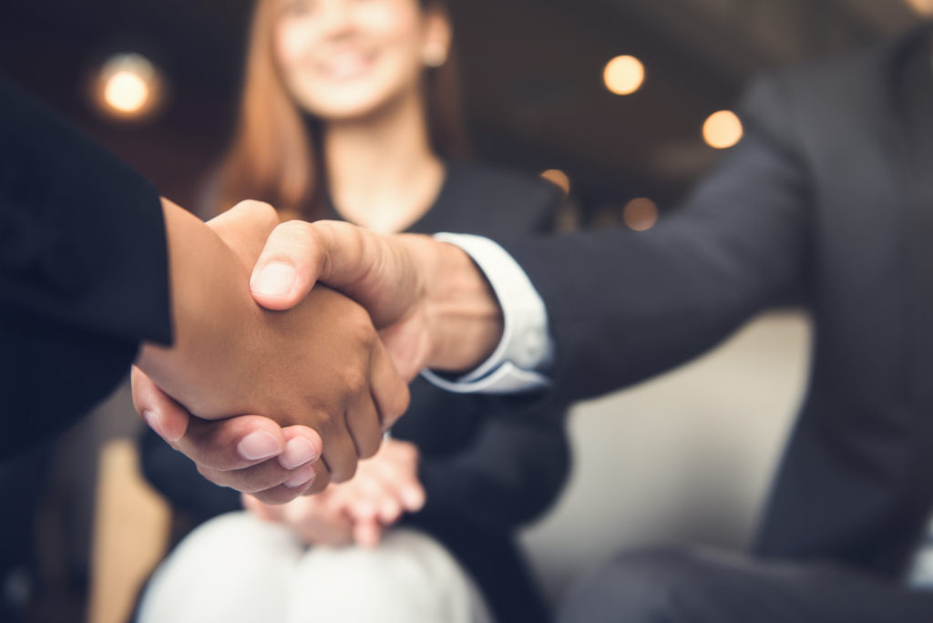 Businessmen making handshake with his partner in cafe - business etiquette, congratulation, merger and acquisition concepts