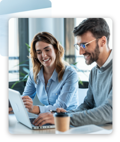 A man and a woman looking at the laptop with smiling faces